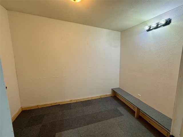 spare room with baseboards