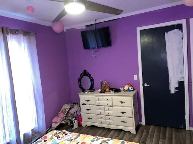 bedroom featuring dark wood-style flooring and ceiling fan