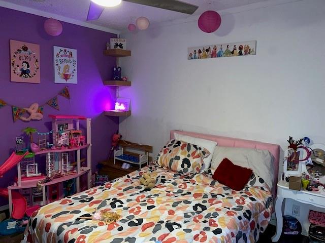 bedroom featuring ornamental molding and ceiling fan