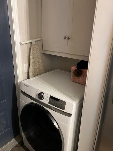 laundry room with washer / clothes dryer and cabinet space