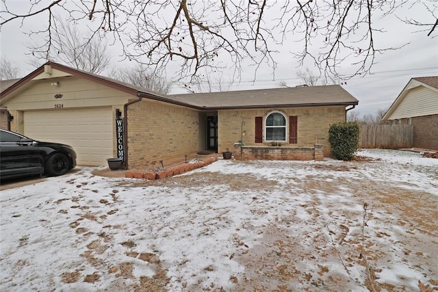 single story home featuring a garage and brick siding