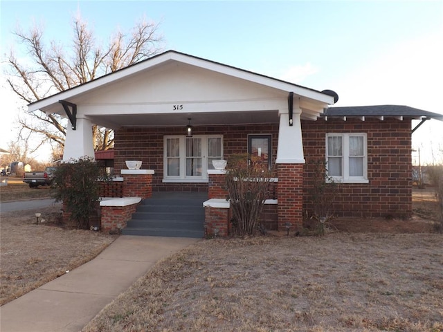 view of front of property with a porch and brick siding