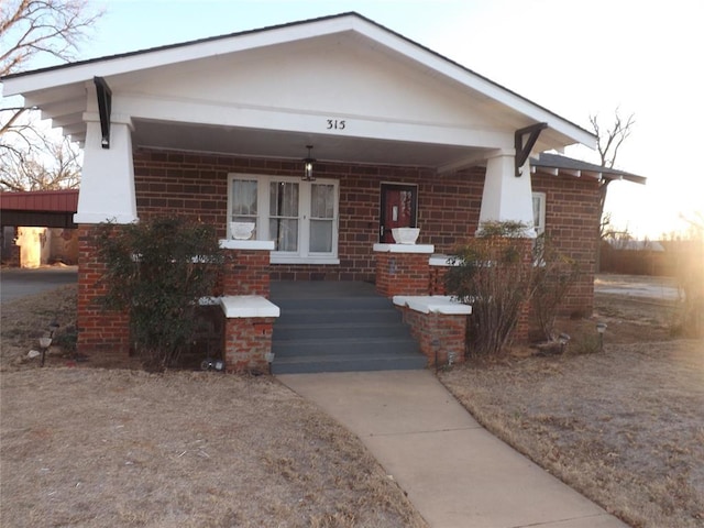 view of front of property with a porch and brick siding