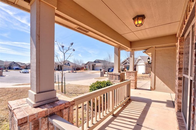 view of patio with covered porch and a residential view