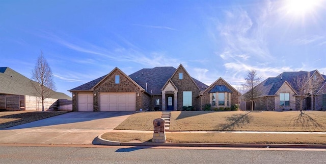 view of front of property with concrete driveway, brick siding, and an attached garage