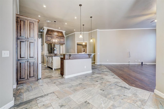 kitchen featuring decorative light fixtures, a spacious island, ornamental molding, open floor plan, and ceiling fan