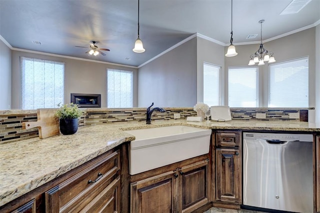 kitchen featuring stainless steel dishwasher, a sink, and a wealth of natural light