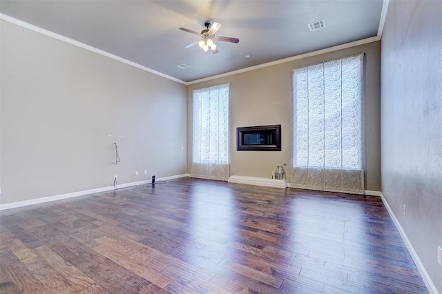 unfurnished room with ceiling fan, dark wood-style flooring, visible vents, and crown molding