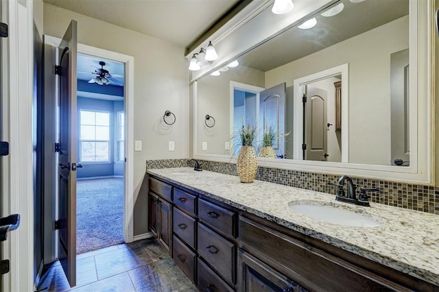 bathroom featuring double vanity, a sink, and decorative backsplash