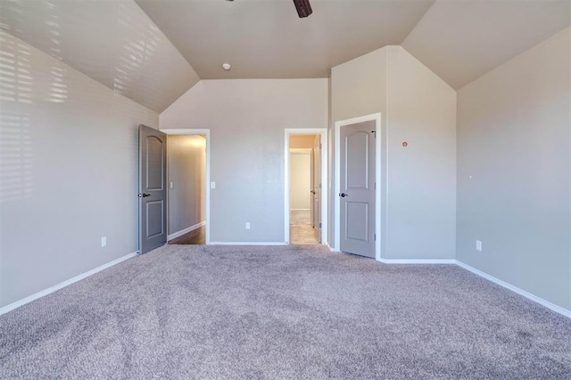 unfurnished bedroom with ceiling fan, carpet, baseboards, and vaulted ceiling