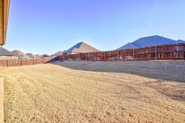 view of yard with a fenced backyard