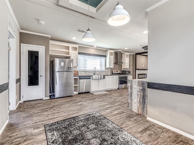 kitchen featuring dark countertops, white cabinetry, appliances with stainless steel finishes, and pendant lighting