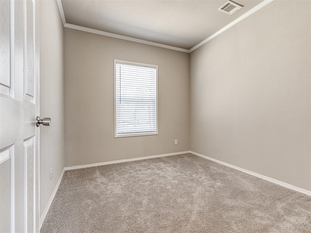 carpeted spare room featuring baseboards, visible vents, and crown molding