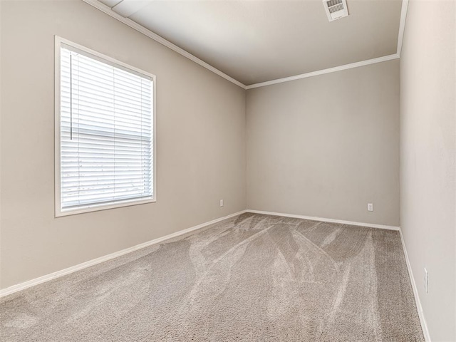 empty room featuring baseboards, visible vents, crown molding, and carpet flooring