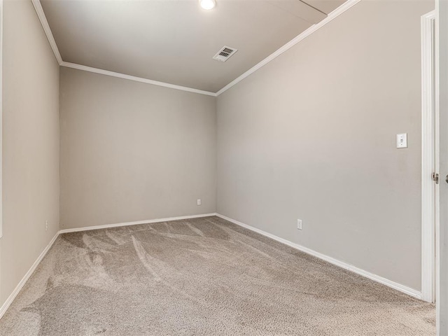 unfurnished room with baseboards, visible vents, ornamental molding, and carpet flooring