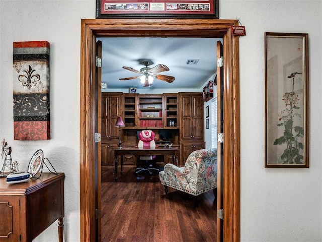 office area with a ceiling fan, visible vents, and wood finished floors