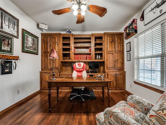 office area with dark wood-style flooring, ceiling fan, and baseboards