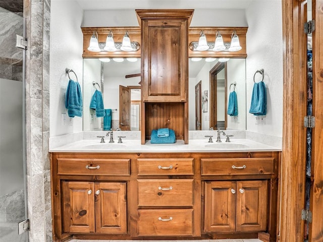 full bath with double vanity, a stall shower, and a sink