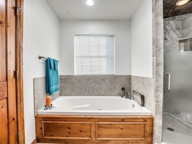 full bath featuring a stall shower and a garden tub