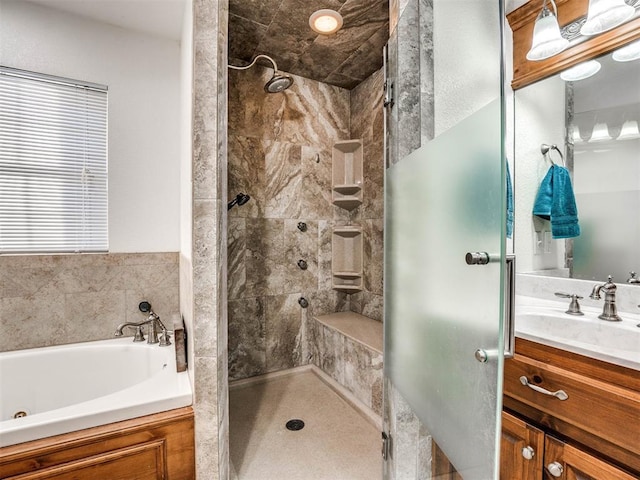 bathroom with a shower stall, a bath, and vanity