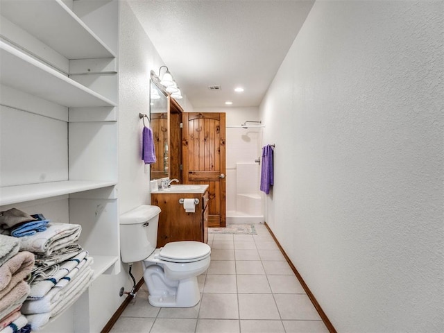 bathroom with tile patterned flooring, toilet, vanity, baseboards, and a shower