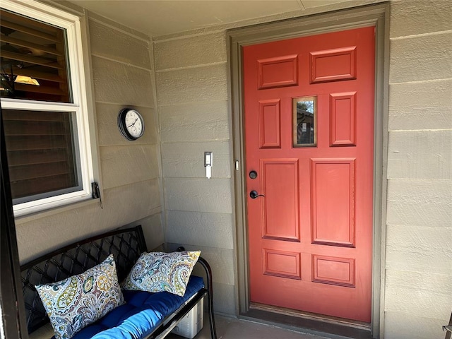 entrance to property featuring concrete block siding