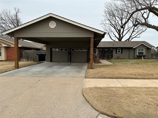 view of front facade with an attached garage, brick siding, fence, a carport, and a front lawn