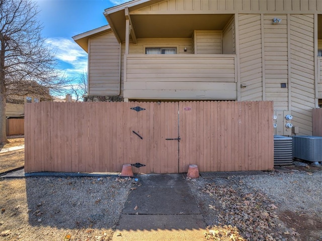 view of property exterior with fence and central air condition unit