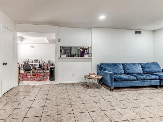 living area with light tile patterned floors and recessed lighting