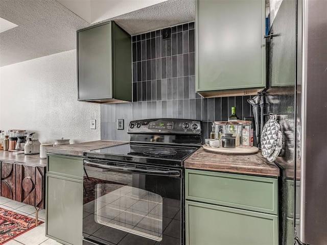 kitchen featuring a textured ceiling, black range with electric cooktop, dark countertops, and green cabinetry