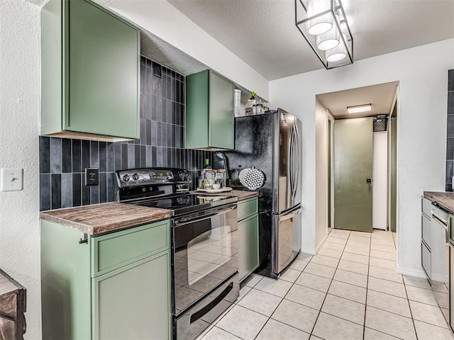 kitchen featuring green cabinets, electric range, and light tile patterned floors