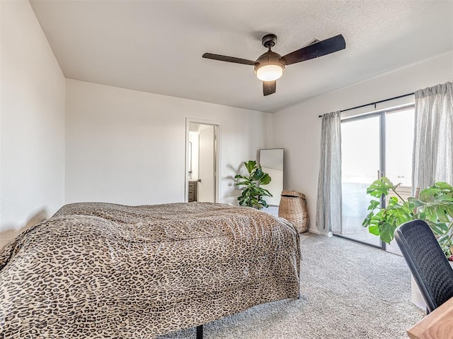 carpeted bedroom featuring access to exterior, ceiling fan, and a textured ceiling