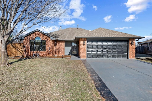 ranch-style house featuring brick siding, a shingled roof, a front yard, a garage, and driveway