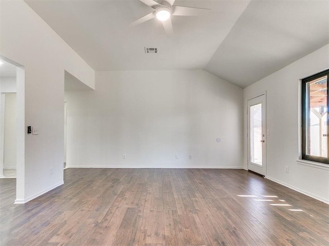 unfurnished room with baseboards, visible vents, dark wood finished floors, a ceiling fan, and vaulted ceiling