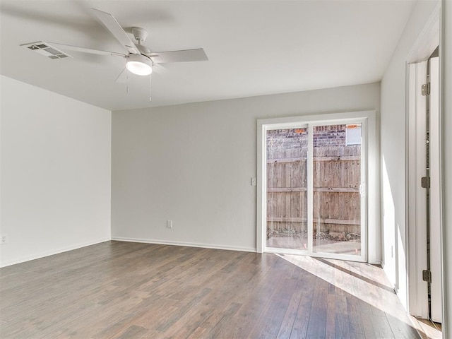 unfurnished room featuring a ceiling fan, baseboards, visible vents, and wood finished floors