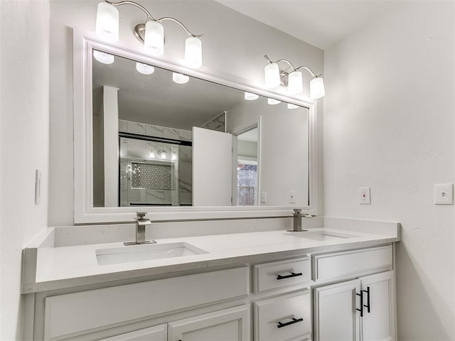 bathroom with a shower with door, a sink, and double vanity