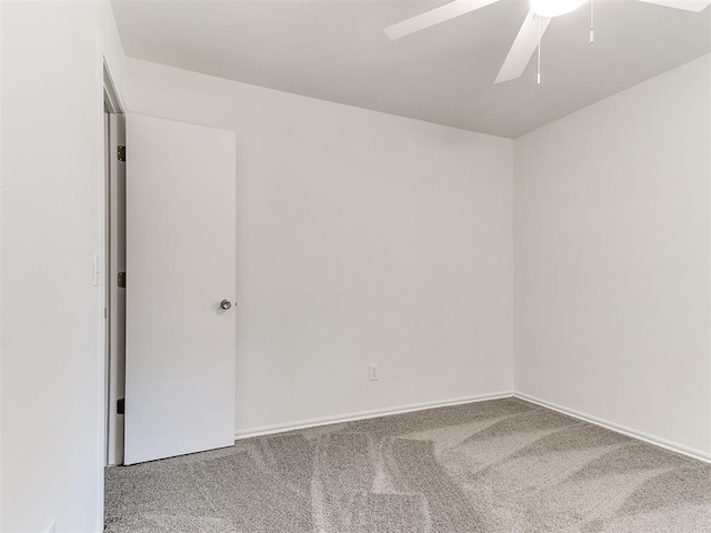 unfurnished room featuring carpet, a ceiling fan, and baseboards