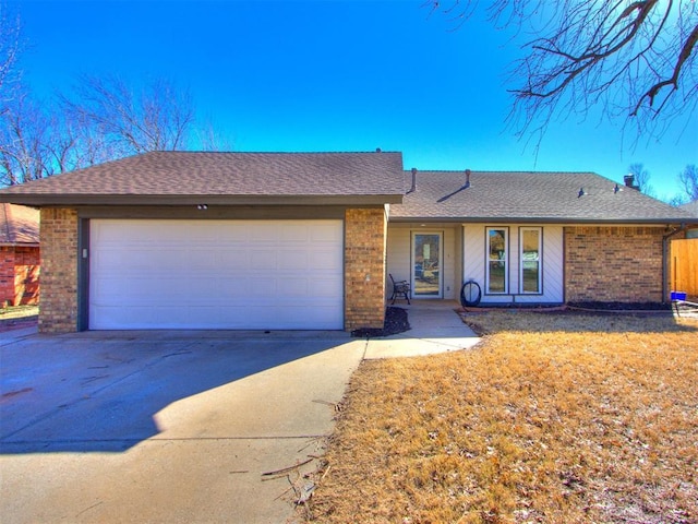 ranch-style home featuring brick siding, an attached garage, concrete driveway, and roof with shingles