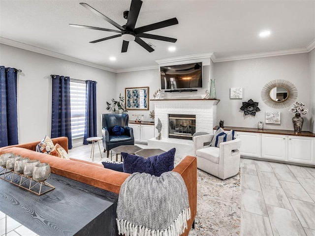 living room featuring ceiling fan, a fireplace, crown molding, and recessed lighting