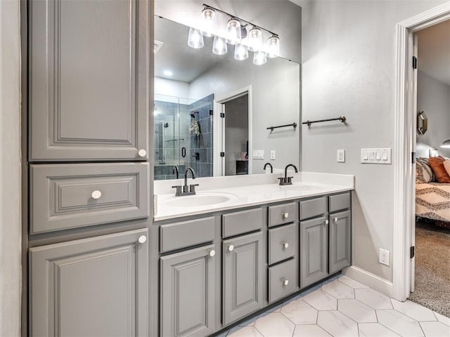 ensuite bathroom with a stall shower, double vanity, a sink, and ensuite bathroom