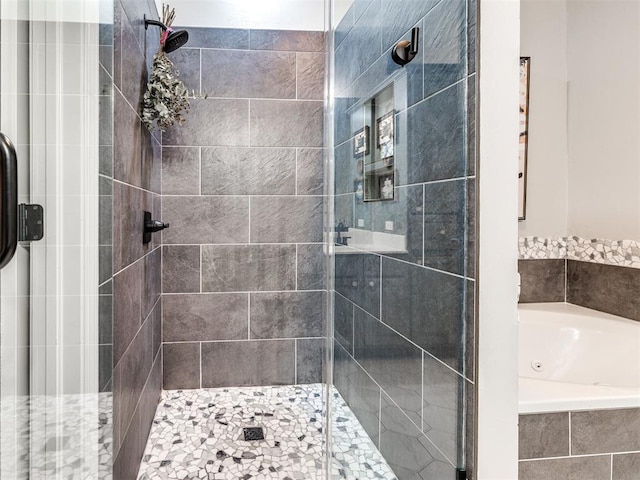 full bathroom featuring a stall shower and a jetted tub