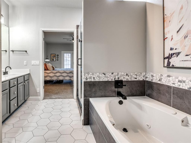 ensuite bathroom with vanity, a ceiling fan, tile patterned floors, a whirlpool tub, and ensuite bath