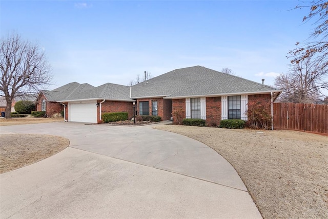 ranch-style house with brick siding, a shingled roof, concrete driveway, fence, and a garage