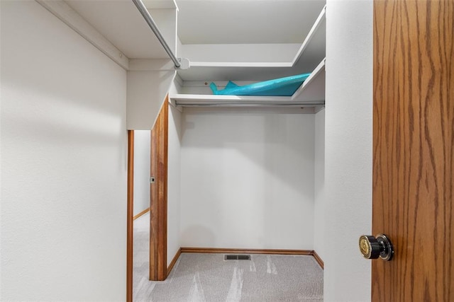 walk in closet featuring visible vents and carpet flooring