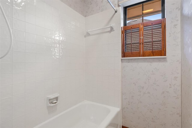 bathroom with  shower combination and wallpapered walls