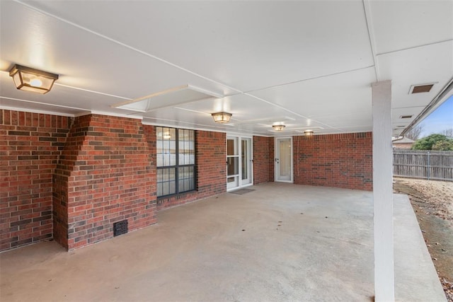 view of patio with visible vents and fence