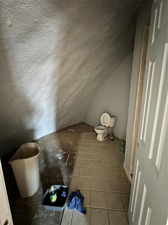 bonus room featuring lofted ceiling and tile patterned flooring