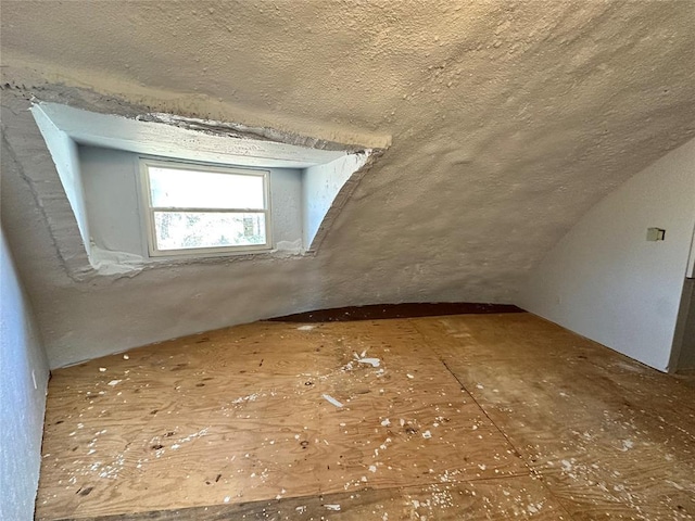 bonus room with a textured ceiling