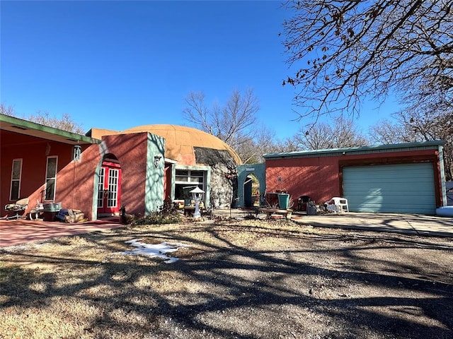 view of front of home featuring a garage, entry steps, and driveway