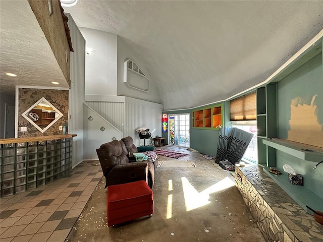 living area with high vaulted ceiling and a textured ceiling